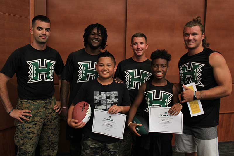 Boys with their instructor holding certificates