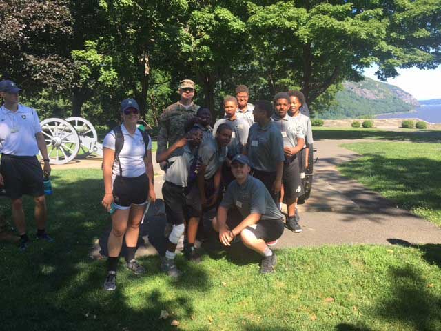 group of students posing with soldier