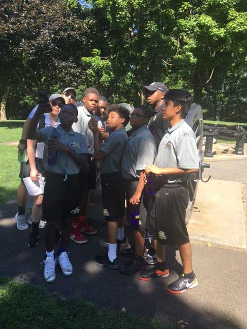 Boy taking selfie with group 