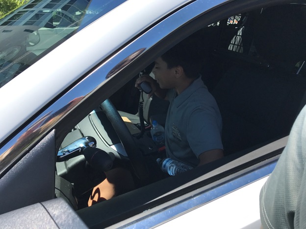 Boy sitting in the white car