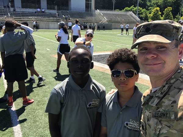 Solider taking selfie with students