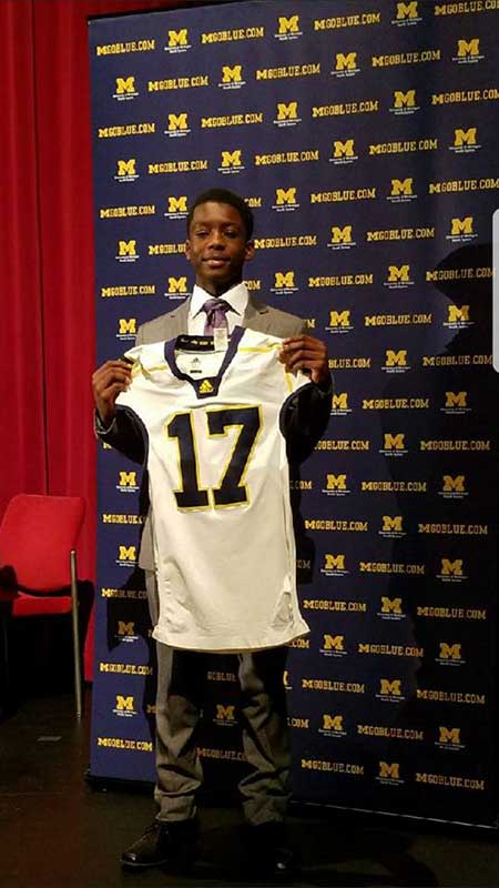 Boy holding a white 17 number jersey