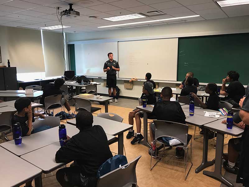 Teacher teaching students in the school