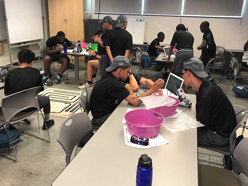 Students sitting in front of laptop