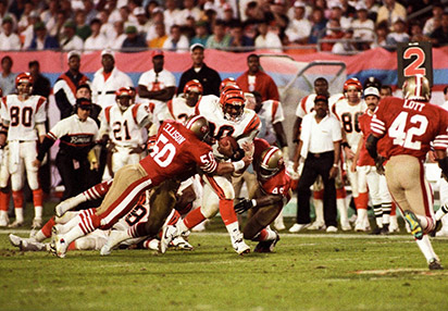 Riki Ellison Founder and CEO, YIP #50, San Fransisco 49ers, tackling Ickey Woods #30 of Cincinnati Bengals during Super Bowl XXIII
